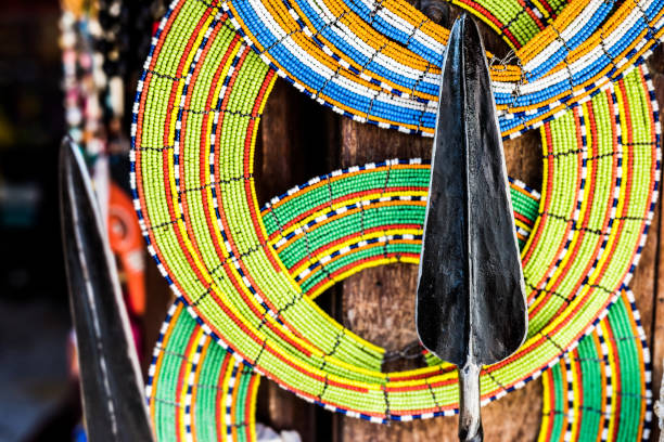 istock Masai colorful decorations and spear at market 1592629937