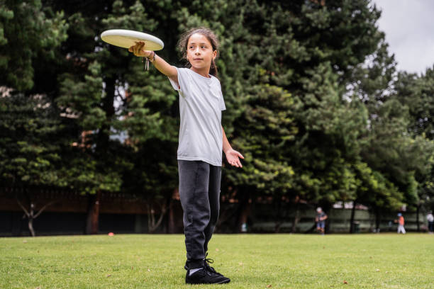 istock Child throwing a frisbee at the public park 1592658155