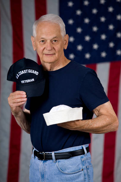 istock United States Coast Guard Veteran holding caps 1592683884