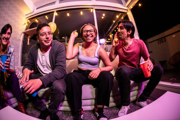 istock Friends having fun while playing beer pong on a party at home 1592689126