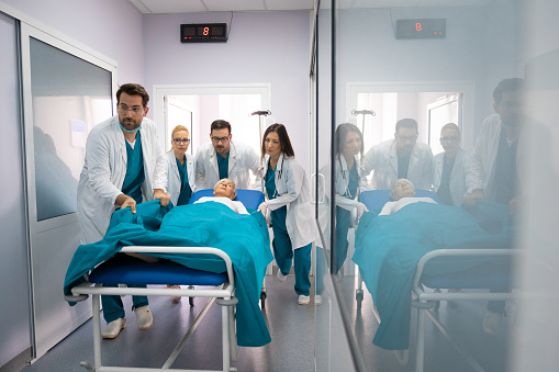 Emergency rescue case of senior female patient and doctors motion movement scene in hospital healthcare service. Medical team in a hurry to save patients life.