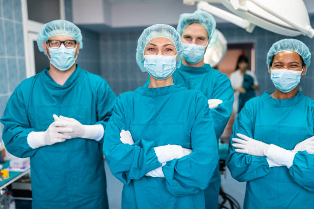 istock Group of confident successful surgeons looking at camera 1592716091