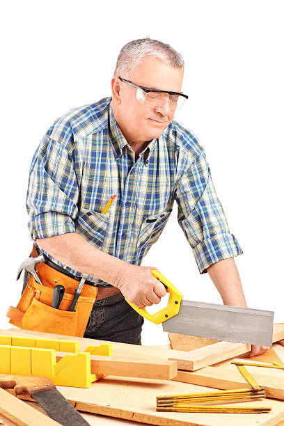 istock Carpenter cutting wooden batten with a saw 159271700