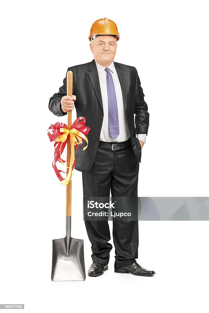 Empresário segurando uma pá com fita do - Foto de stock de Homem de negócios royalty-free