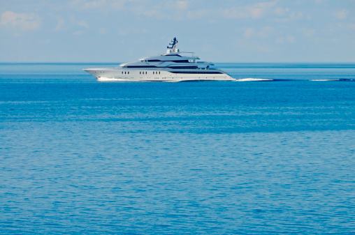 A large motor yacht under way out at sea, copy space