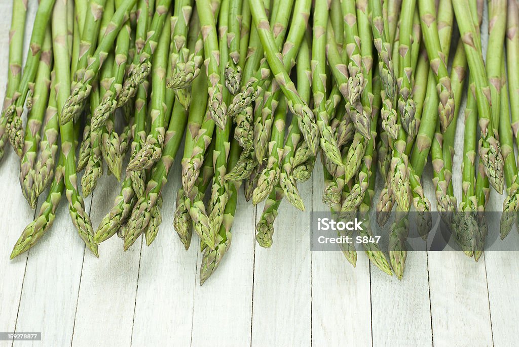 Asparagus asparagus sprouts on white wooden table Asparagus Stock Photo