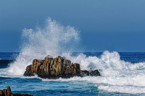 Large turbulent ocean wave crashing on off-shore rocks, off the California Coast, after a pacific coast storm had passed through the area.

Taken at Monterey, California, USA