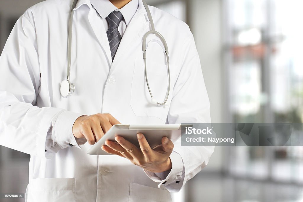 Doctor using a digital tablet Adult Stock Photo