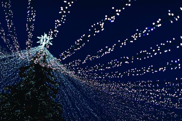 istock Silver blue magic twinkling bokeh lights of Christmas tree. 1592821330