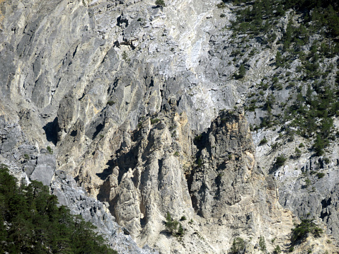 Steep rocks and the consequences of erosion on the slopes of alpine canyons above the picturesque alpine valley of the river Albula or Alvra - Canton of Grisons, Switzerland (Kanton Graubünden, Schweiz)