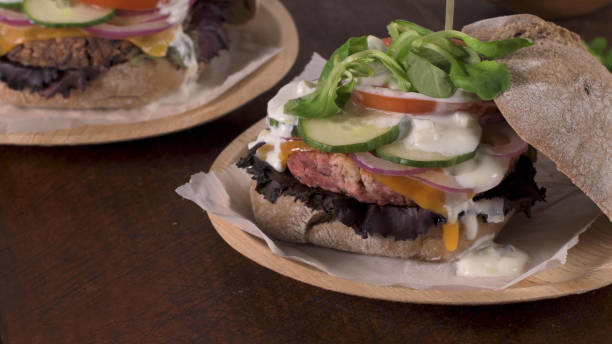 istock Healthy vegan burger with fresh vegetables and yogurt sauce 1592955982