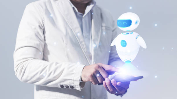 istock Businessman holding a tablet with a robot hologram on the screen 1592962721