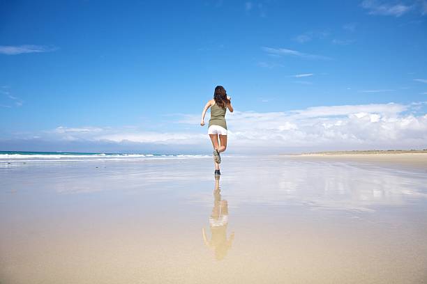 istock back sportswoman running on seaside 159299892