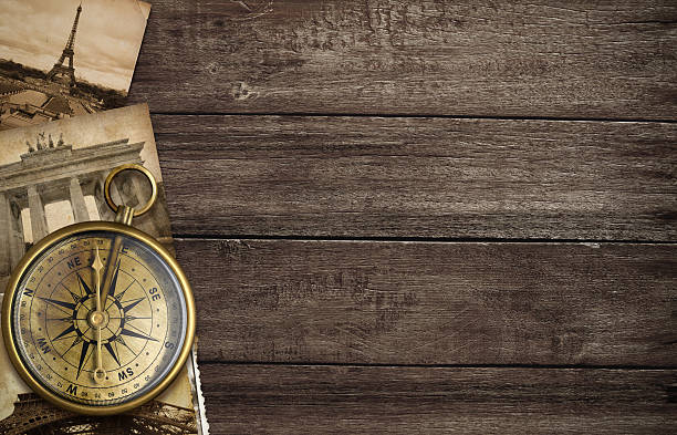 istock brass antique compass on table with old postcards and landmarks 159300454