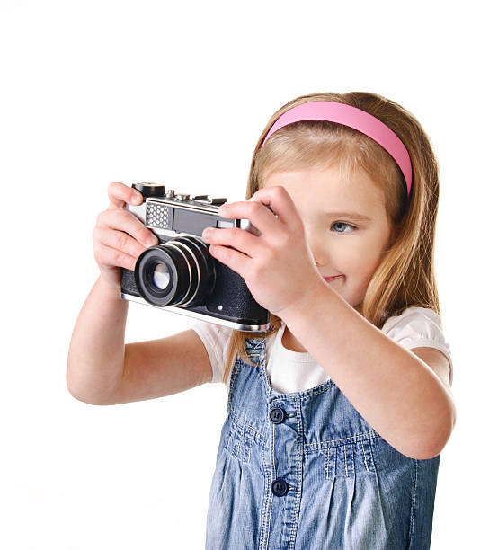 istock Photographing little girl with old camera isolated 159308801