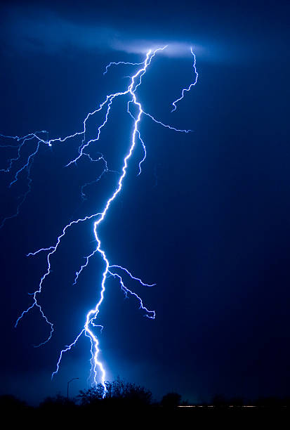 istock A large bolt of lightning in a lit up blue night sky 159310171