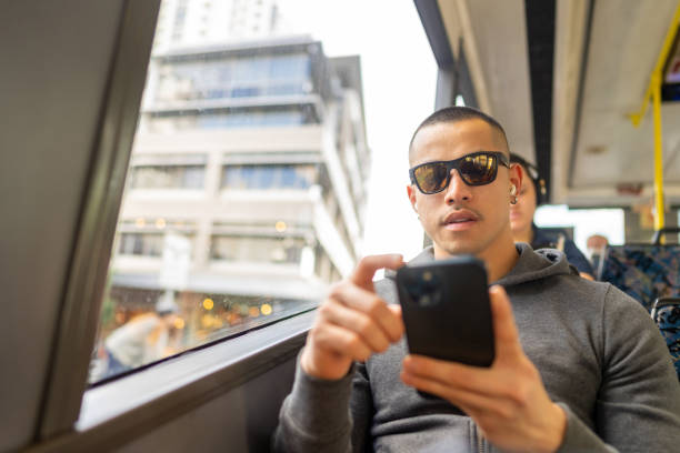istock Asian man using mobile phone on the bus. 1593107547