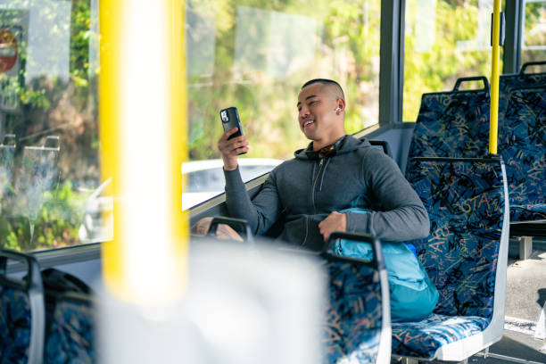 istock Asian man using mobile phone on the bus. 1593107553