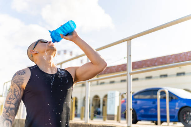 istock Asian man drinking water after jogging exercise at seaside 1593110695