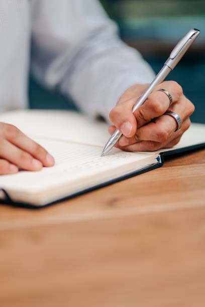 istock businessman writing some bullet points on a paper 1593125573