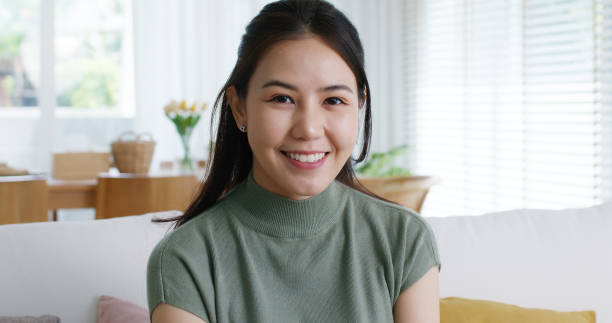 istock Reskill upskill for young adult talent workforce remote work anywhere at home hybrid workplace. Asia Gen Z woman sit easy at cozy sofa couch learn online MBA look at camera smile relax health care. 1593135055