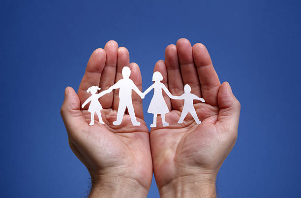 istock Paper chain family protected in cupped hands 159315336