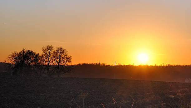 istock sunset over farm land 159317351