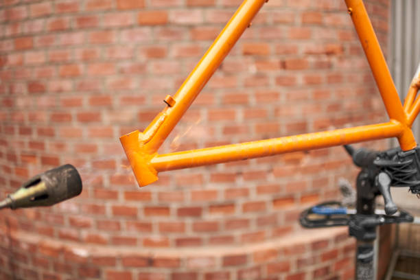 istock Unrecognizable person using a blowtorch to remove the paint of a bicycle frame 1593185845