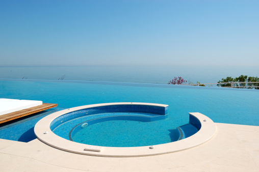 Infinity swimming pool with hot tub by beach at the modern luxury hotel, Pieria, Greece