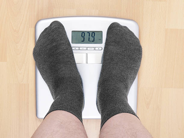 istock overweight man on scales 159322914