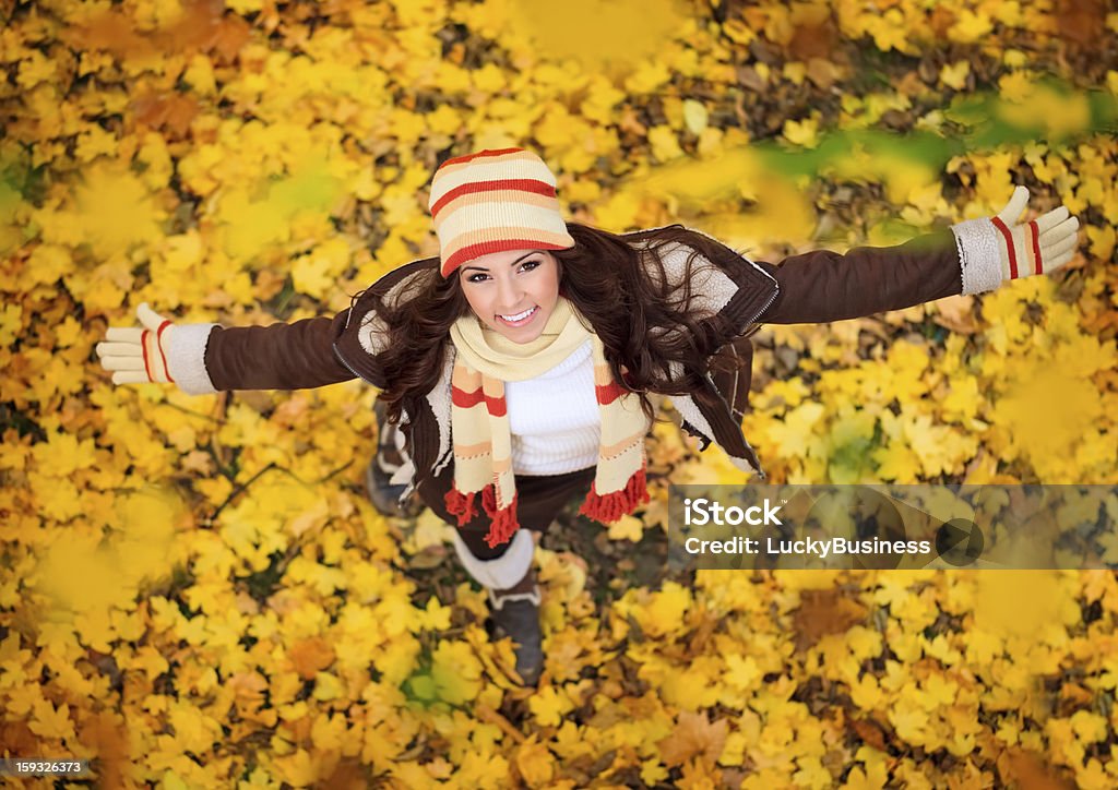 Happy woman playing in autumn happy lovely and beautiful woman in forest in fall colors, celebrating coming autumn Adult Stock Photo