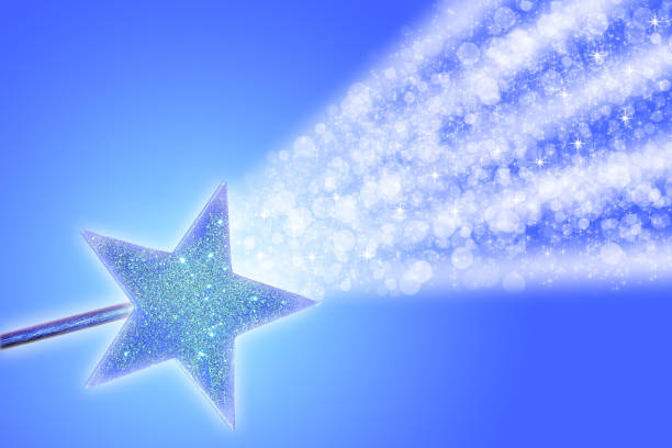 Sparkling white particles radiate out from a magic wand across a blue sky.