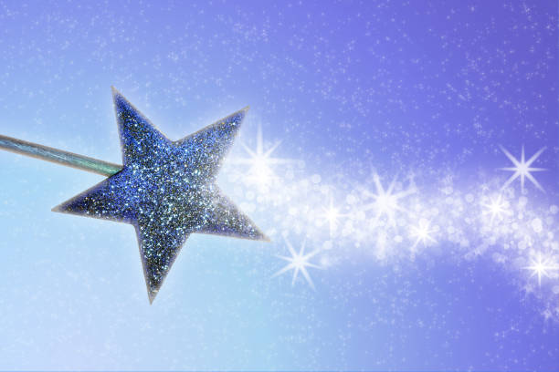 istock A golden-blue magic wand on a blue background projects a white trail of star dust. 1593301898