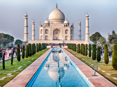 The Taj Mahal with reflection in courtyard pool in Agra, India.