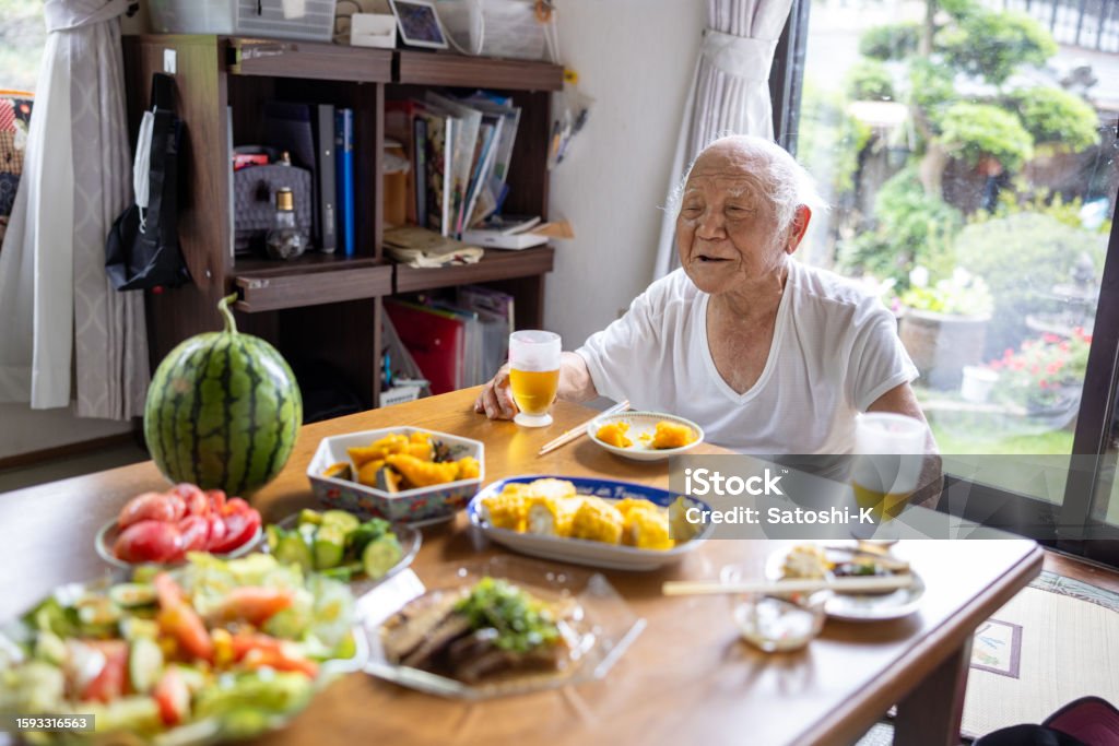 Senior man having lunch at home 80-89 Years Stock Photo
