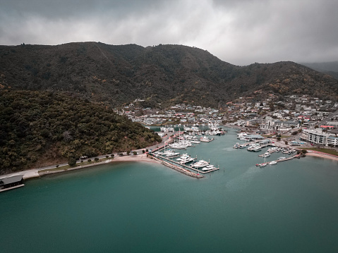 A drone shot taken above the ocean looking back into land at Picton's Marina in New Zealand