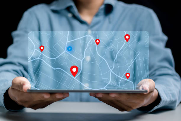 istock Businessman searching for location on map and pin on virtual screen. GPS app, Destination travel maps and find places in the online system 1593337318