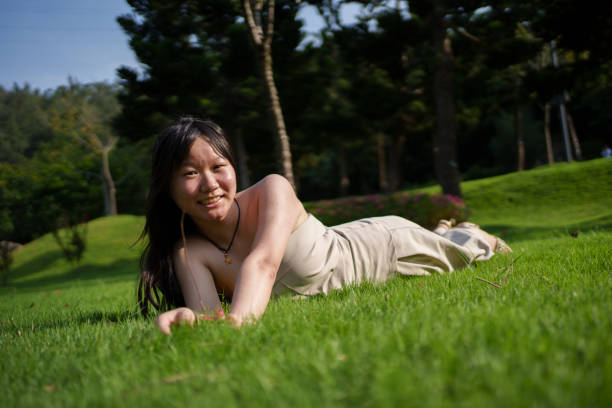 Asian woman lying on the grass