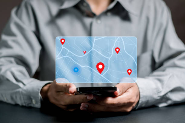 istock Businessman searching for location on map and pin on virtual screen. GPS app, Destination travel maps and find places in the online system 1593337362