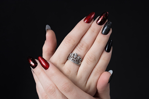 Bright festive red manicure on female hands. Nails design.