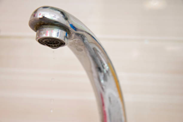 istock Drops of water falling down from the crane 1593349667