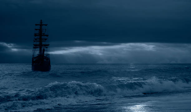 istock Sailing old ship in a storm sea in the background stormy clouds 1593360336