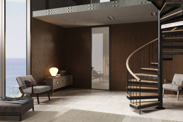istock Apartment with a large panoramic window with sea view and spiral staircase. Modern interior design. 1593373675