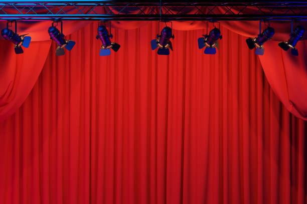 istock Empty theater stage with red velvet curtains and spotlights. 1593383015