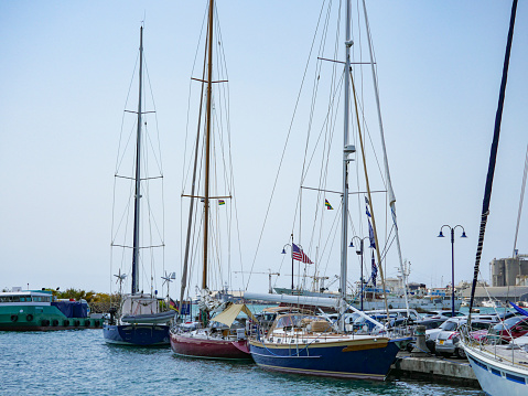 Port-Louis, Mauritius - October 31, 2019 : yacht with American flag moored amongst others at marina in Port-Louis waterfront