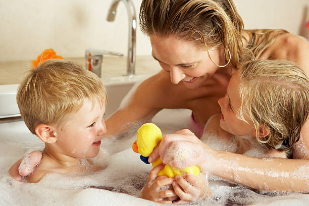 istock Mother With Children Relaxing In Bubble Filled Bath 159340318