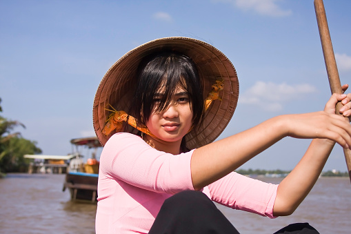 Ho-Chi-Minh,Vietnam, Asia- August 20,2023:Arm of the Mekong Delta, woman in traditional rowing boat, Can Tho, Mekong Delta, Vietnam, Southeast Asia
