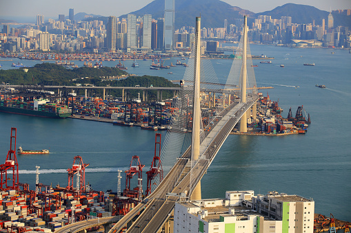 Kwai Tsing container terminal port view in drone, and hong kong skyline and stonecutter's bridge