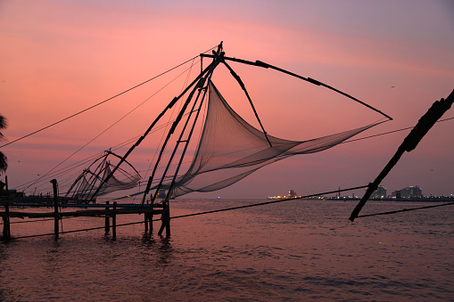 Sunset over Chinese fishing net at sunrise in Cochin Fort Kochi, Kerala, India.