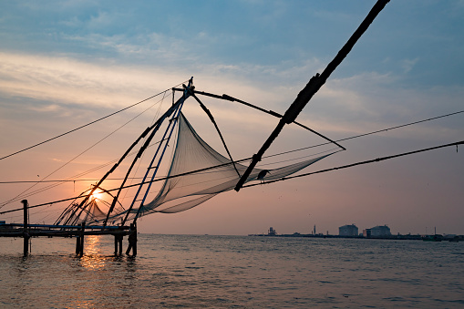 Sunset over Chinese fishing net at sunrise in Cochin Fort Kochi, Kerala, India.